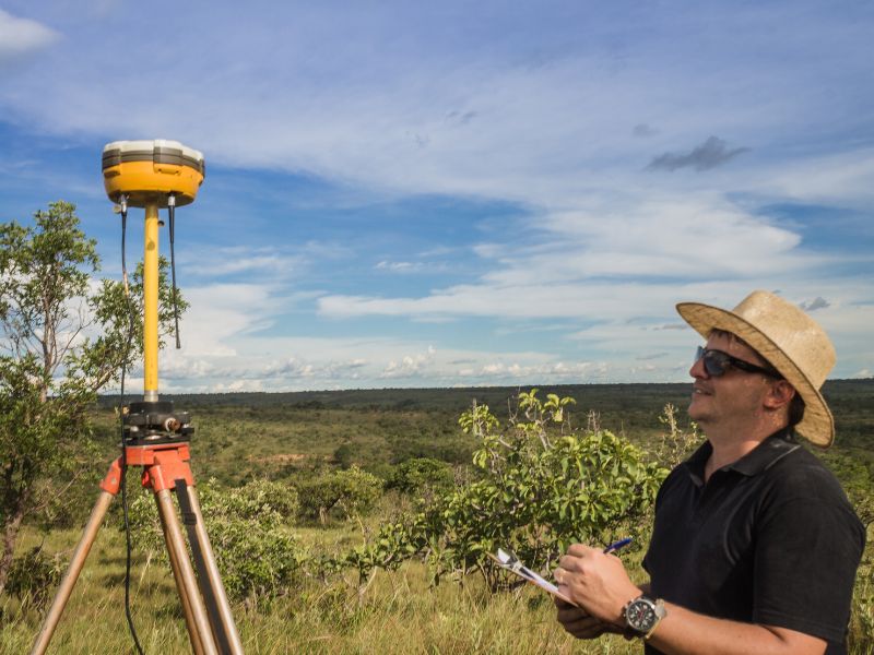 Surveyor using GPS equipment for survey mapping to collect land measurements and create accurate property and topographic maps
